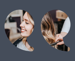 Beautiful young woman with perfect hairstyle satisfied after dyeing hair and making highlights in hair salon